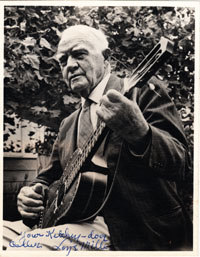 old photo of "Padre" Loye Miller playing guitar, autographed